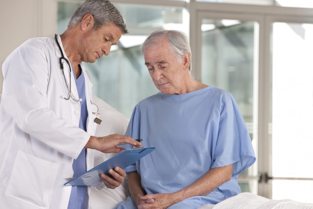 Doctor explaining a medical chart to an elderly patient