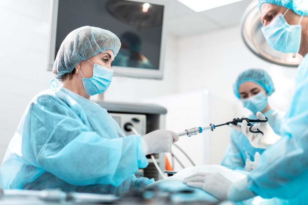 Doctors using a large machine during surgery